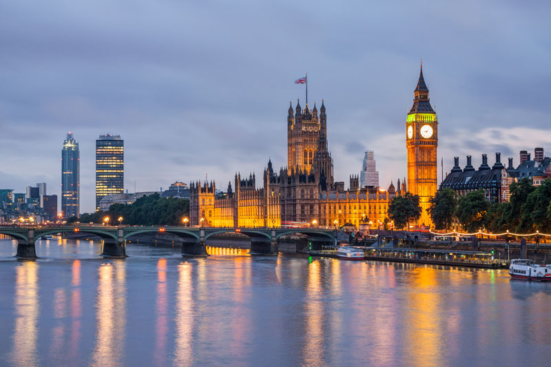 A view of the Houses of Parliament and Big Ben across the River Thames in London at dusk